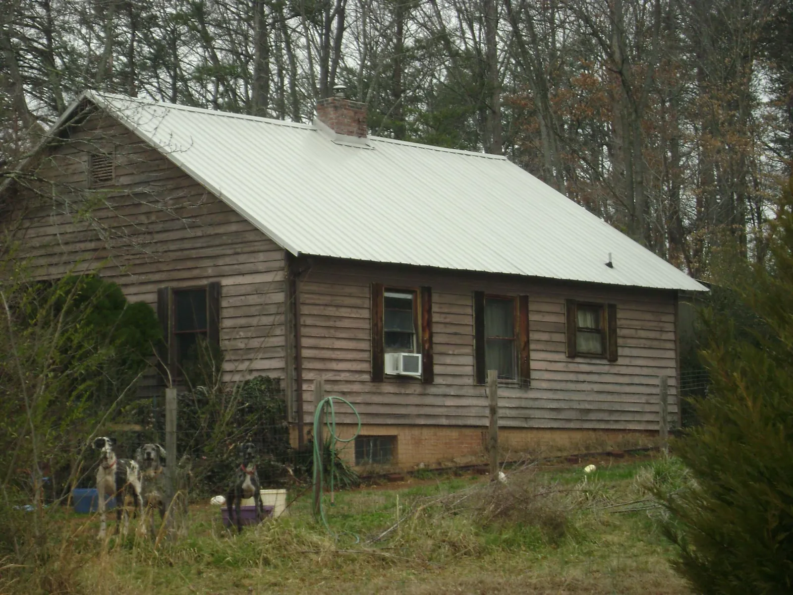 White metal roof on an old wood sided farmhouse, from a Asphalt Shingle Roof Repair job in Line Lexington